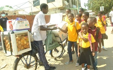 • Adanfo selling to some kids at the Salvation Army School at Laterbiokorshie Photos Lizzy Okai