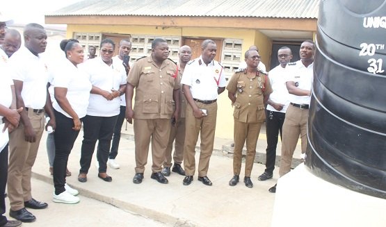 ●●Members of the group handing over the tank