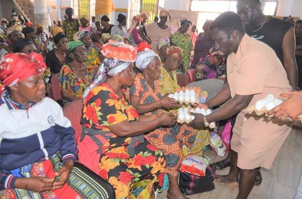 • Prophet Benson (right) with his team distributing the food items to some of the beneficiaries. Photo: Godwin Ofosu-Acheampong