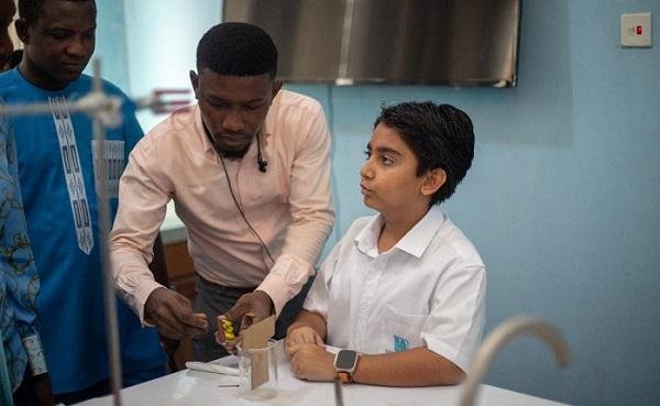 Ateacher helping a student in a science laboratory