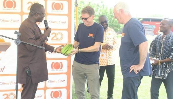 • Dr Acheampong(left)presenting bananas to Mr Rich at the programme