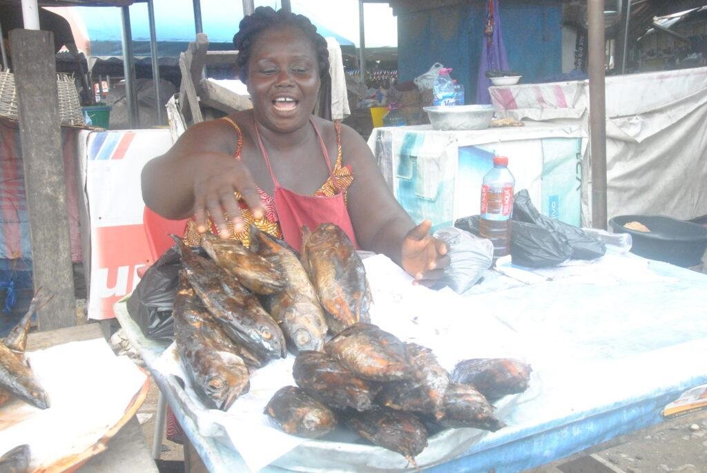 Madam Ama Joyce selling smoke fish .