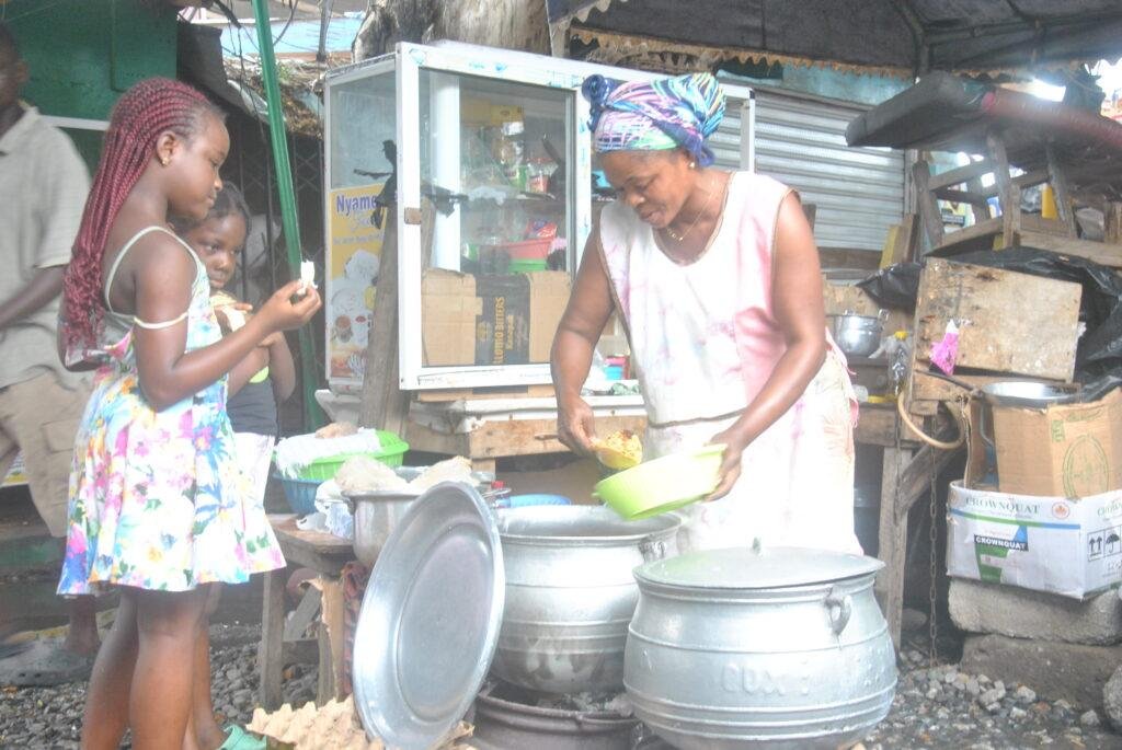 Ms Akua Boatemaa serving the children with rice.