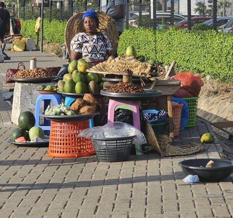 A woman selling on a pavement