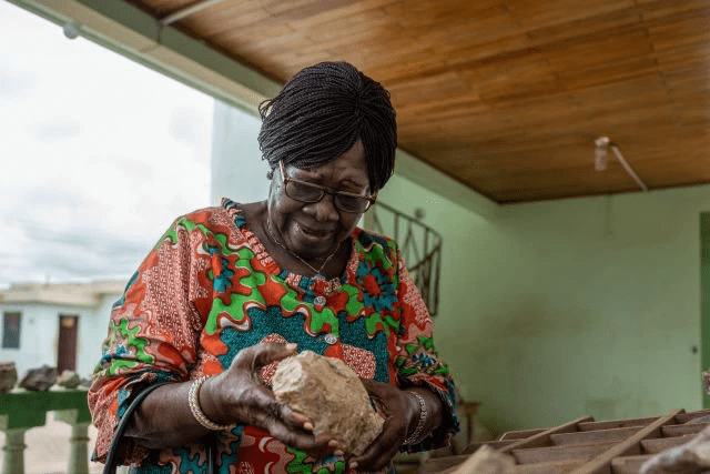 Mrs Amoako Mensah, inspecting rock samples at the Ewoyaa Lithium Project site in Mankessim