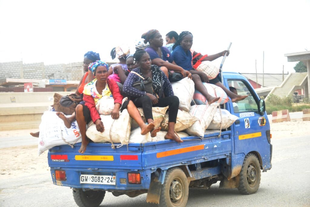 Some mothers seating on top of their foodstuffs in a moving vehicle on the Nsawam Road Photo Elizaabeth Okai