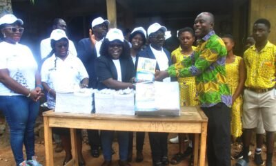 Prof. Alice Mensah presenting the books to Mr Bright Loggah the headteacher of Mpehnasem Methodis Basic school with the staff of ATU and pupils Photo: Lizzy Okai