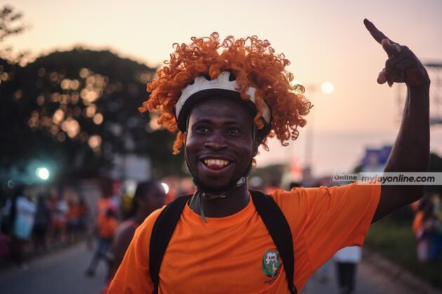 An excited fan draped on orange