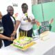 • Mr Felix Afutu (middle) cuts a cake with Opoku-Agyemang (right) and Adomako-Mensah (left) to officially launch the festival