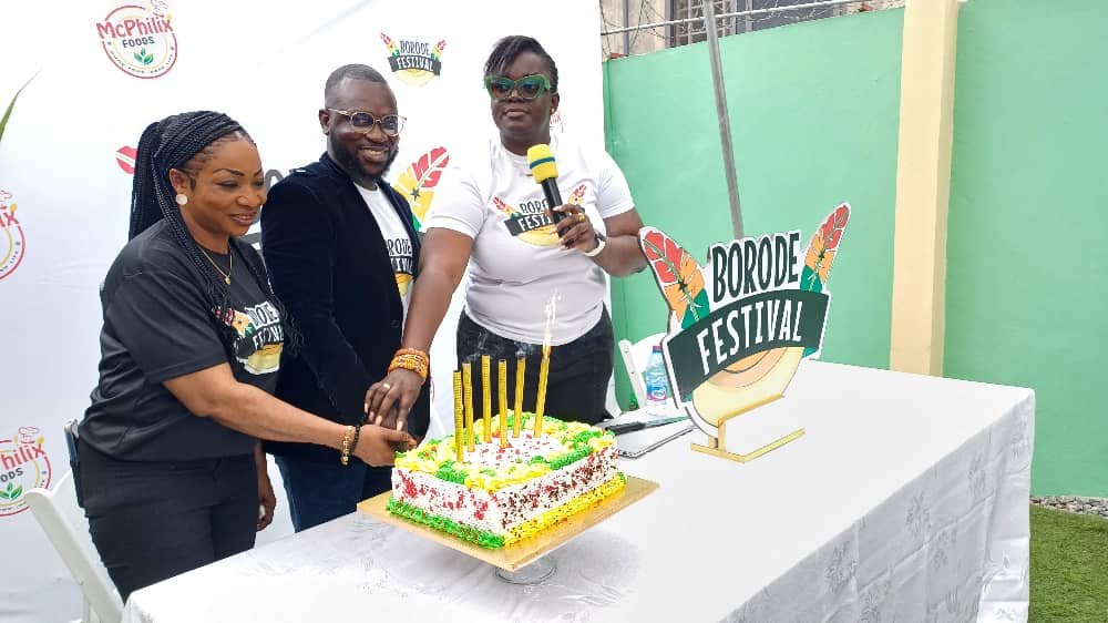 • Mr Felix Afutu (middle) cuts a cake with Opoku-Agyemang (right) and Adomako-Mensah (left) to officially launch the festival