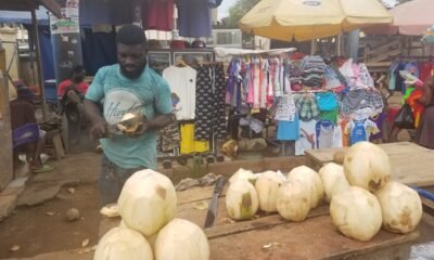 Michael peeling coconut to sell