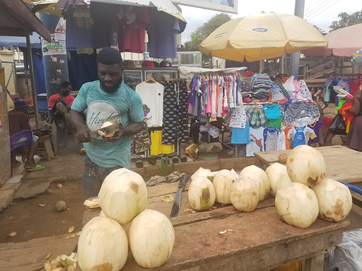 Michael peeling coconut to sell