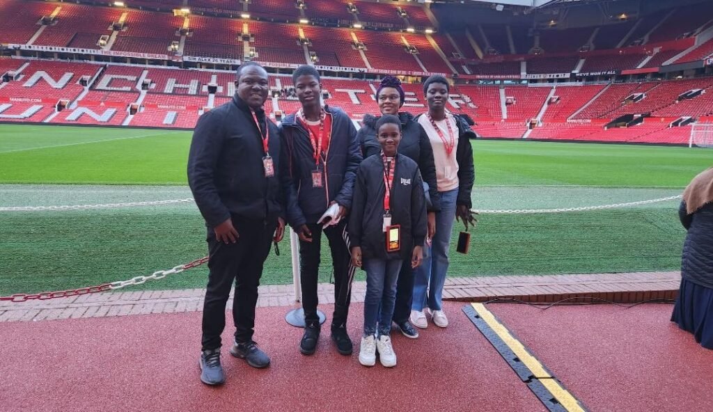 Mr Antwi and his family at Manchester United stadium UK