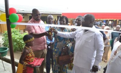 Mr Nikoi (second right) being assisted by (Mrs. Kotomah (middle) to cut the tape for the commissioning of the building programme Photo Victor A. Buxton