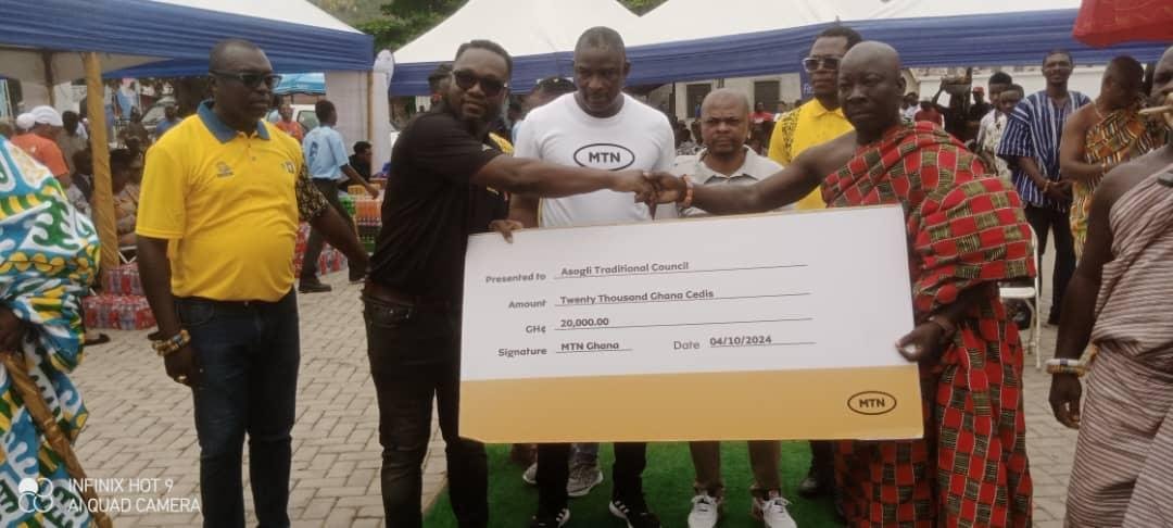 • Mr Ransford Gyan ( second from left) presenting the cheque to Togbe Adzima III