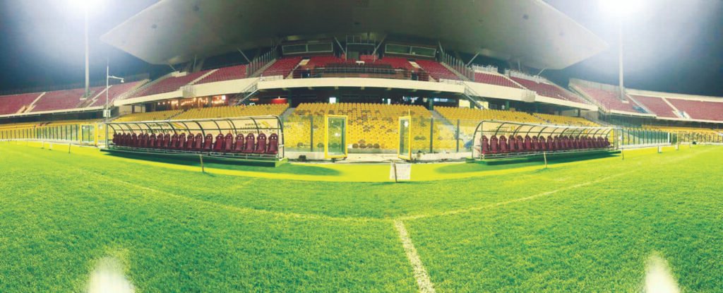 The green pitch with a new set of substitution benches