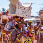 A woman carrying a stool on her head