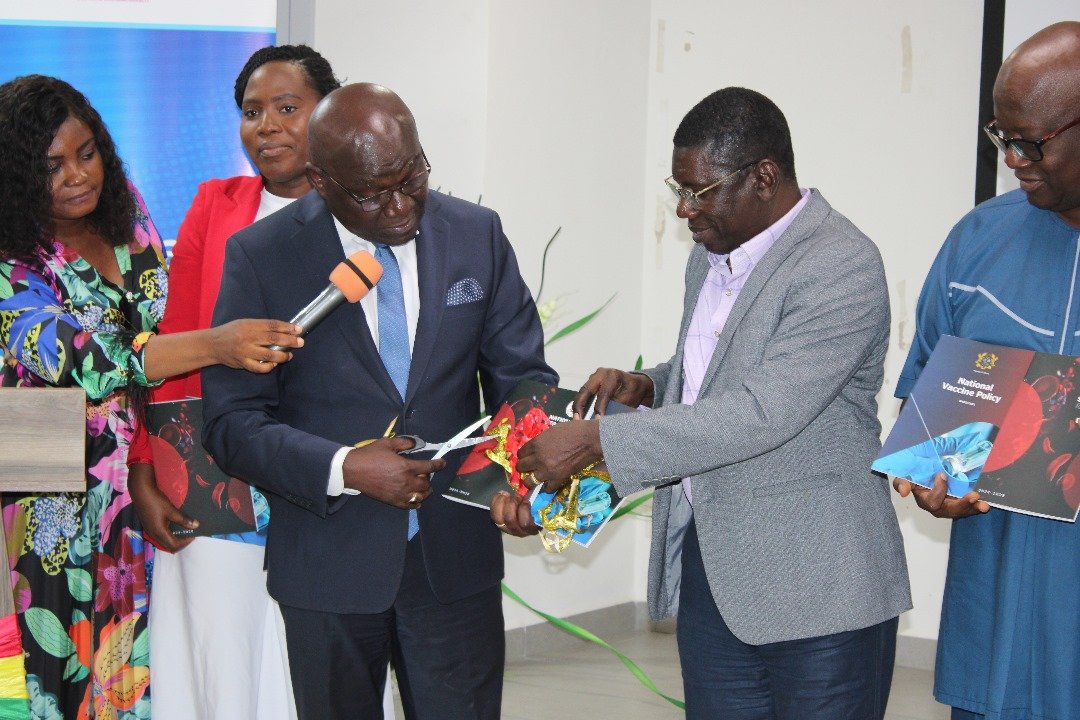 Dr. Dairus Osei, Technical Advisor to the Ministry being assisted to cut the ribbon and launch the documents