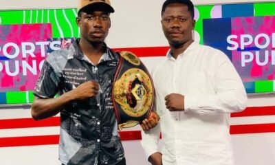 Coach Carl Lokko (right) and John Laryea display a title belt