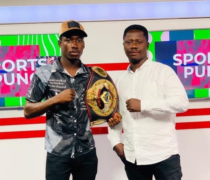 Coach Carl Lokko (right) and John Laryea display a title belt