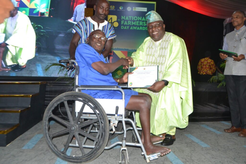 Mr. Jokeman Dzotefe(left) receiving from Mr. Seth Kwame Acheampong,theEastern Regional Minist, the Volta Regional Best Physically Challenged Best Farmer Award  Photo Victor A. Buxton