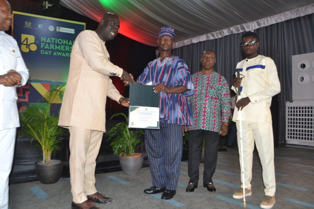 Mr. Mabanye Emmanuel (second from left) receiving the Oti Regional Best Physically Challenged Farmers Award   Phoot Victor A. Buxton