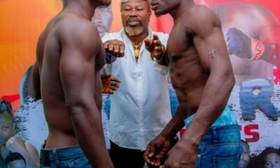 Ayitey Powers separates the two boxers, Elvis Aworgah (left) and Ernest Baubali at the weigh in ahead of their National Super Middleweight clash