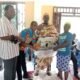 • Dr Ofori -Atta, (left) Nene Adjanor, (Second from right), and Sika receiving her sewing machine