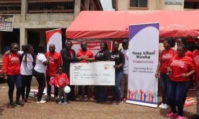 Ms Mireku presenting a dummy cheque to a representstive of the hospital