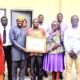 Mrs Quaittoo (third from right) and Alhaji Abdul- Rahaman (third from left) holding the certificate . With them are other Management Staff of NTC and GSA staff Photo; Stephanie Birikorang