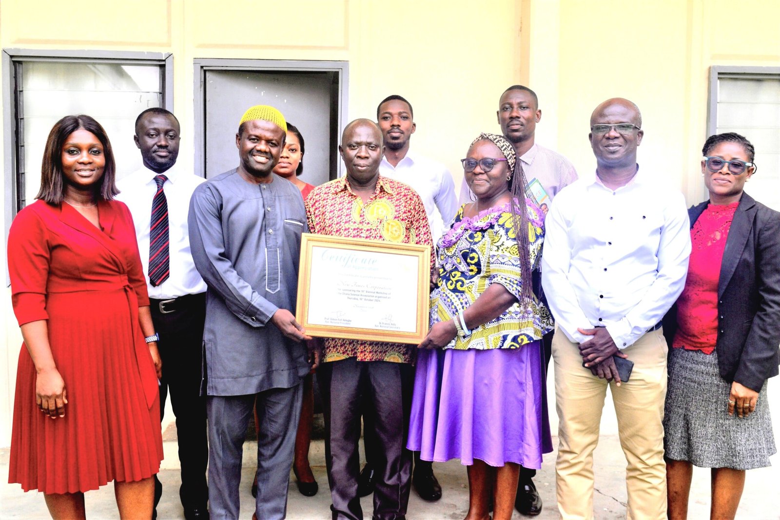 Mrs Quaittoo (third from right) and Alhaji Abdul- Rahaman (third from left) holding the certificate . With them are other Management Staff of NTC and GSA staff Photo; Stephanie Birikorang