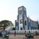 Some people walking Infront of the Catholic church in Ouidah