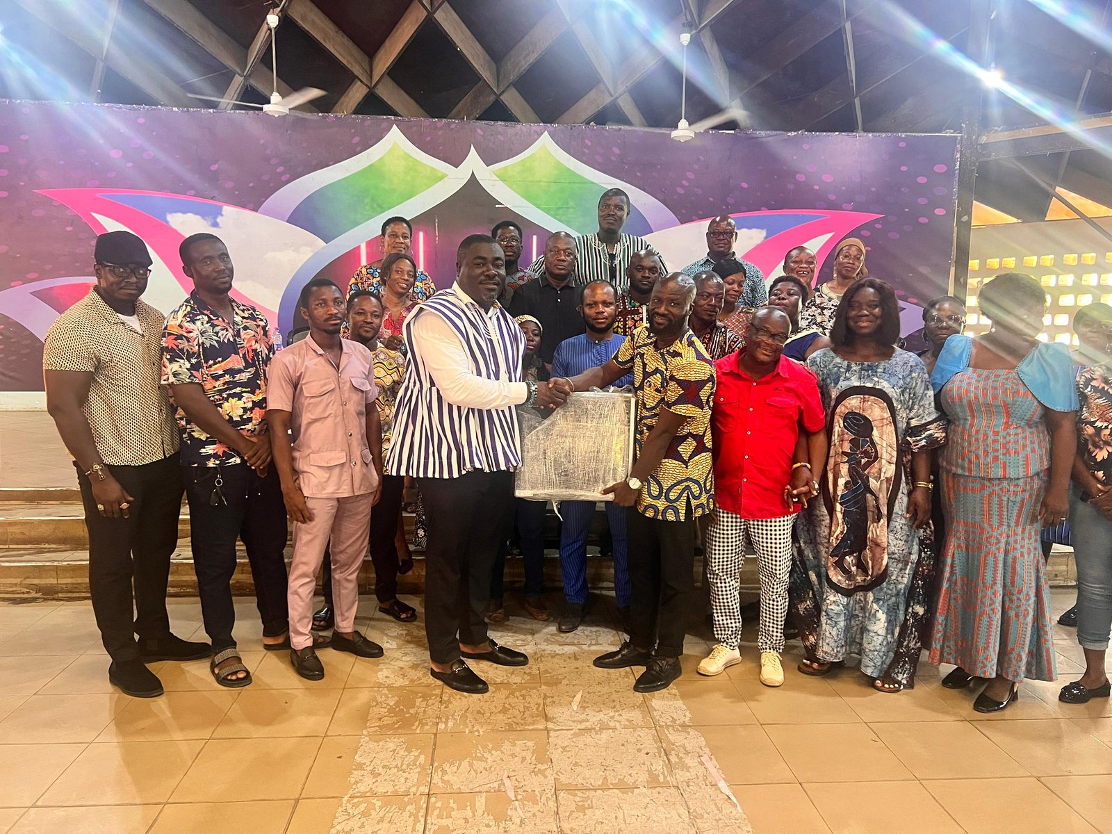 • Mr. Peter Kofi Marfo, in smock & white presenting to Mr. Isaac Fynn, the Dean of the District Cultural Officers receiving