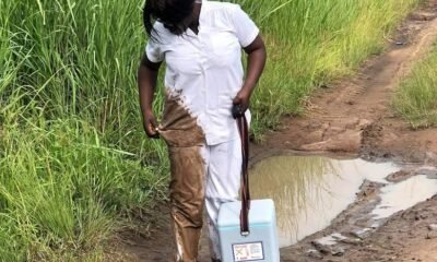 Ms Angela looking at her soiled uniform after falling in a mud