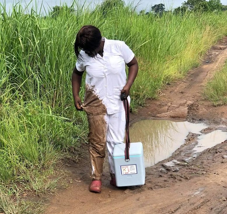 Ms Angela looking at her soiled uniform after falling in a mud