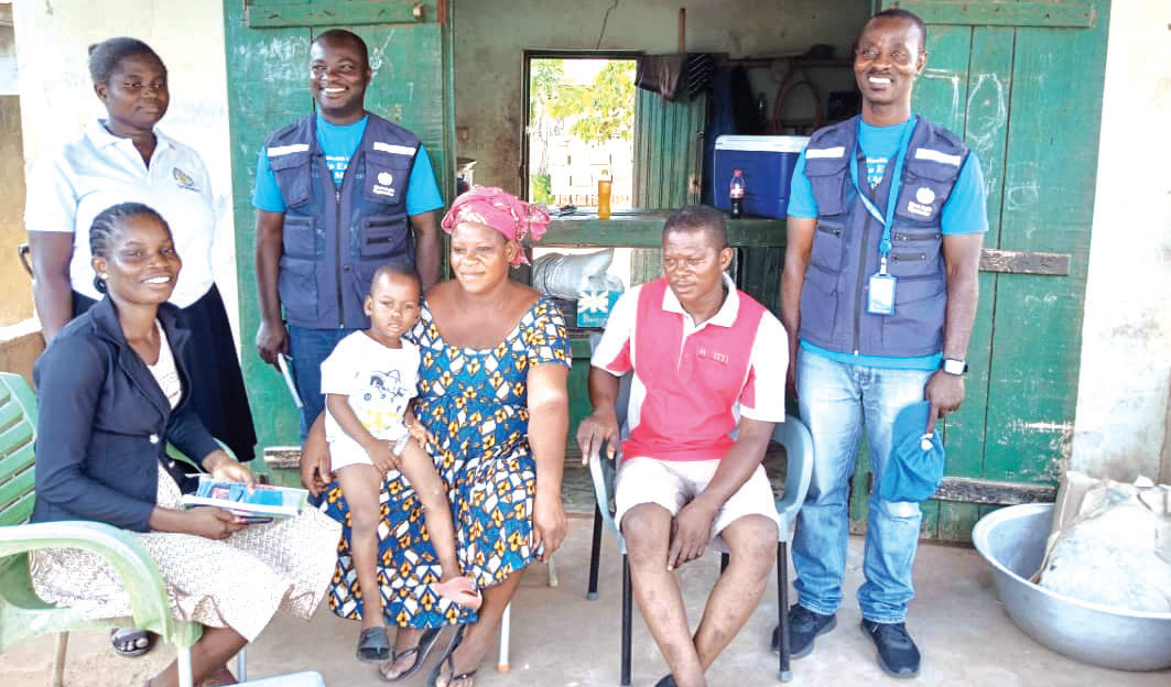 • A group picture of the team and the family after successful vaccination